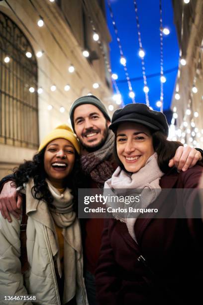 vertical selfie of a mixed raced friends. - group selfie stock-fotos und bilder