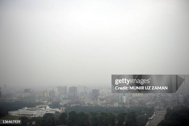 Dense fog blankets the skyline of Dhaka on January 6, 2011. The spell of cold weather that gripped the country, causes hardship for many of the...