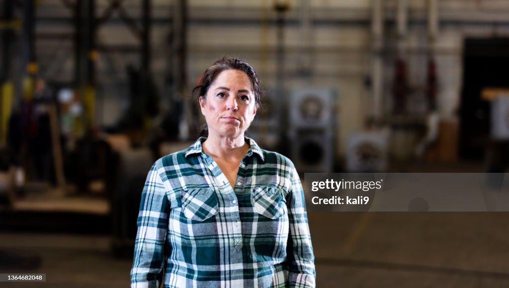 Mature woman standing in warehouse