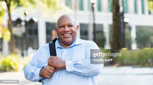 senior black man with large build, in city - fat guy stock pictures, royalty-free photos & images