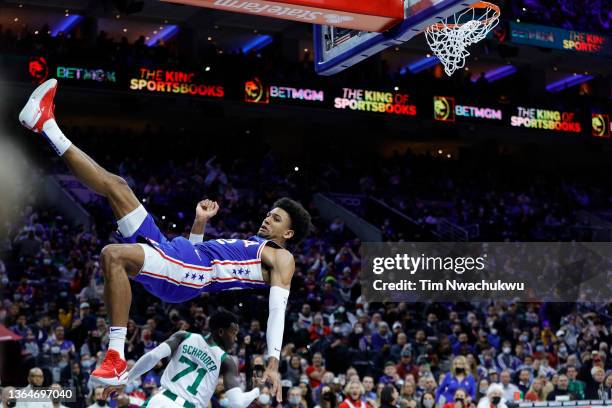 Matisse Thybulle of the Philadelphia 76ers is airborne following a dunk during the third quarter against the Boston Celtics at Wells Fargo Center on...