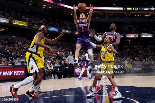 Devin Booker of the Phoenix Suns grabs a rebound in the second quarter against the Indiana Pacers at Gainbridge Fieldhouse on January 14, 2022 in...