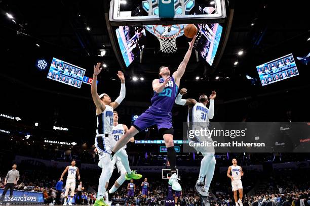 Gordon Hayward of the Charlotte Hornets drives between R.J. Hampton and Terrence Ross of the Orlando Magic during the second half of their game at...