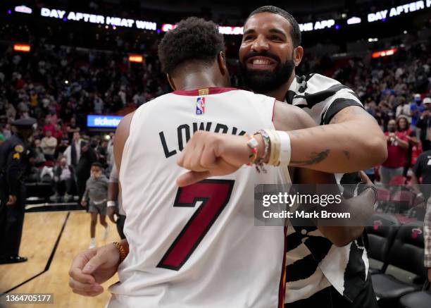 Drake celebrates with Kyle Lowry of the Miami Heat after they defeated the Atlanta Hawks by score of 124-118 at FTX Arena on January 14, 2022 in...