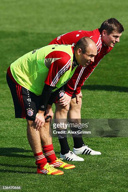 Arjen Robben and Toni Kroos look on during a training session of Bayern Muenchen at the ASPIRE Academy for Sports Excellence on January 6, 2012 in...