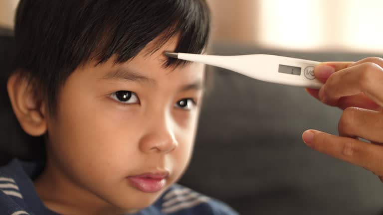 measuring - sick video Images High Quality Grahic Sick Boy With Thermometer Videos and HD Footage - Getty Images