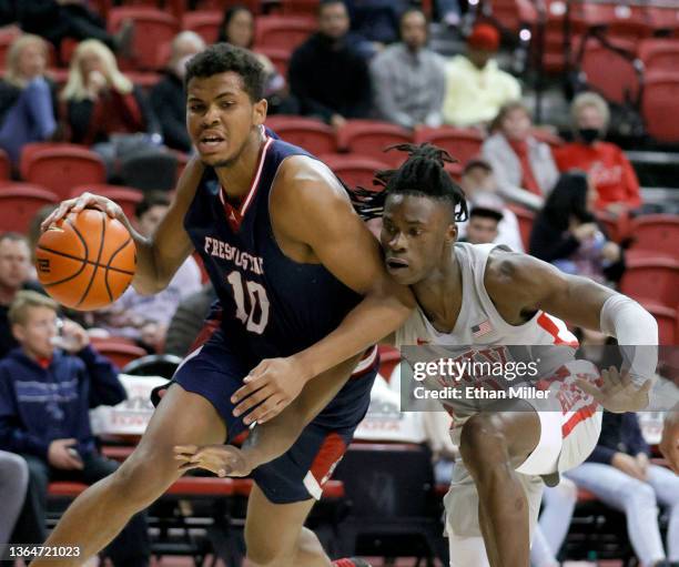 Victor Iwuakor of the UNLV Rebels fouls Orlando Robinson of the Fresno State Bulldogs during their game at the Thomas & Mack Center on January 14,...