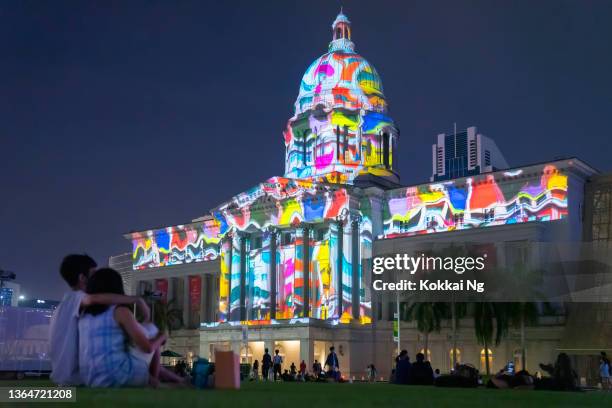 singapore art week - couple watching projection on national gallery of singapore - couple art gallery stock pictures, royalty-free photos & images