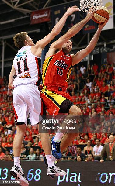 Cameron Tovey of the Wildcats and Liam Rush of the Tigers contest a rebound during the round 14 NBL match between the Perth Wildcats and the...