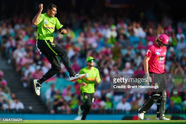 Gurinder Sandhu of the Thunder celebrates after taking the wicket of Jack Edwards of the Sixers during the Men's Big Bash League match between the...