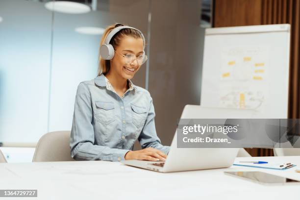 businesswoman in office attending video call - teen entrepreneur stock pictures, royalty-free photos & images