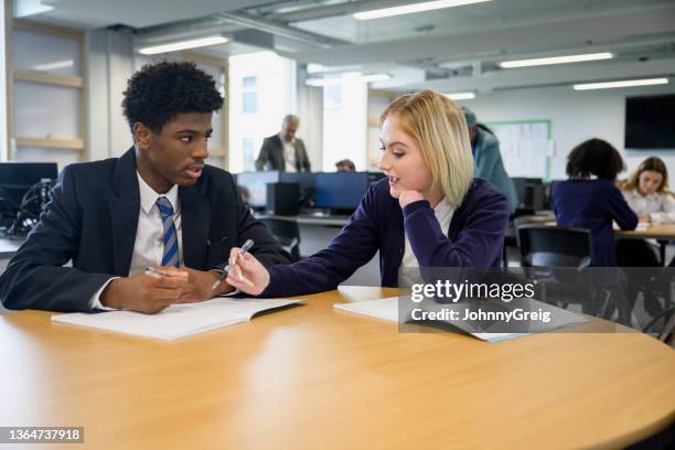 teenage classmates debating ideas in collaborative workspace - secondary school london stock pictures, royalty-free photos & images