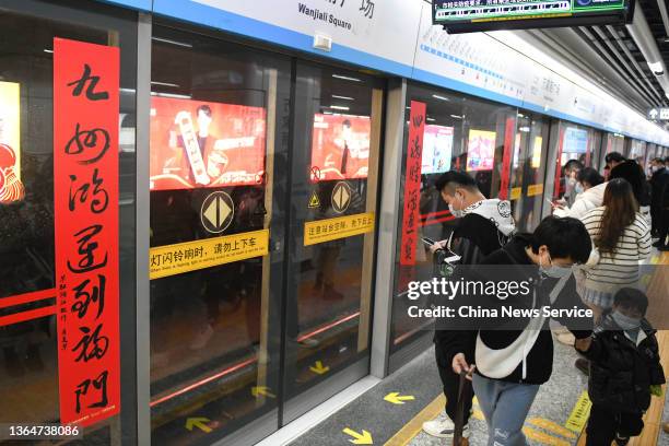 Pair of Spring Festival couplets are seen on the platform screen door of a metro station ahead of the Chinese New Year, the Year of the Tiger, on...