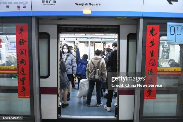 Pair of Spring Festival couplets are seen on the platform screen door of a metro station ahead of the Chinese New Year, the Year of the Tiger, on...