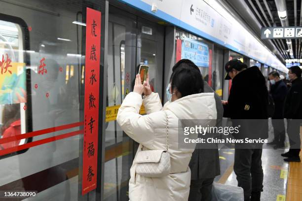 Pair of Spring Festival couplets are seen on the platform screen door of a metro station ahead of the Chinese New Year, the Year of the Tiger, on...
