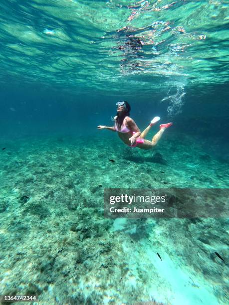 young woman snorkeling in es calo, formentera - islas baleares fotografías e imágenes de stock