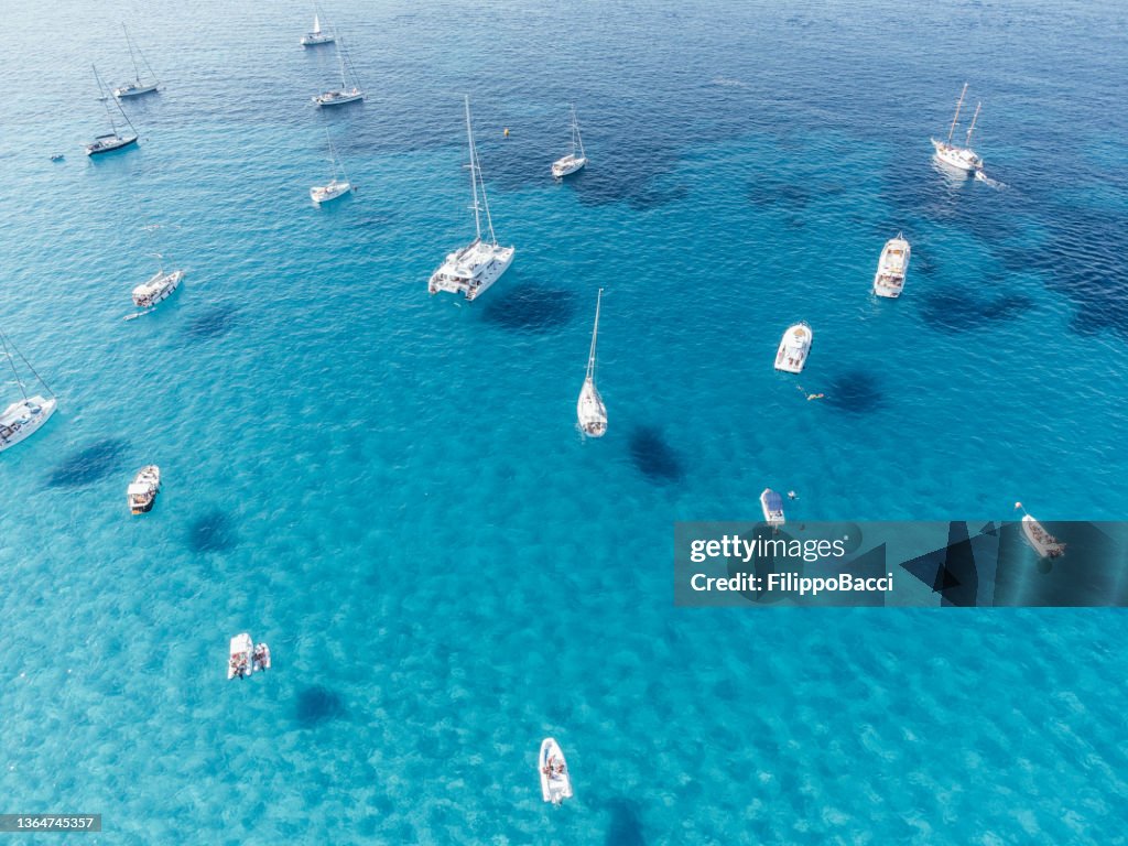 Many boats moored in Cala Rossa, one Favignana Island's beach