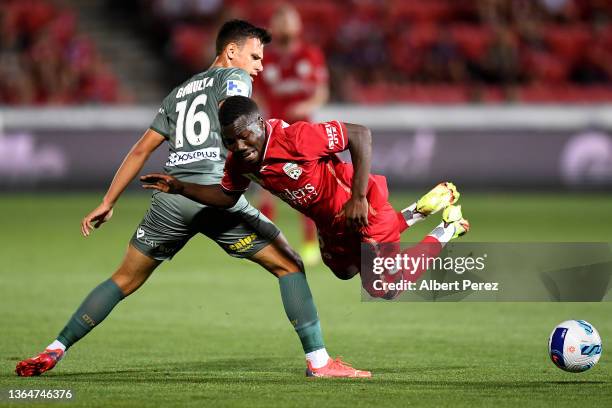 Nestory Irankunda of Adelaide United is tackled by Taras Gomulka of Melbourne City during the round 10 A-League match between Adelaide United and...