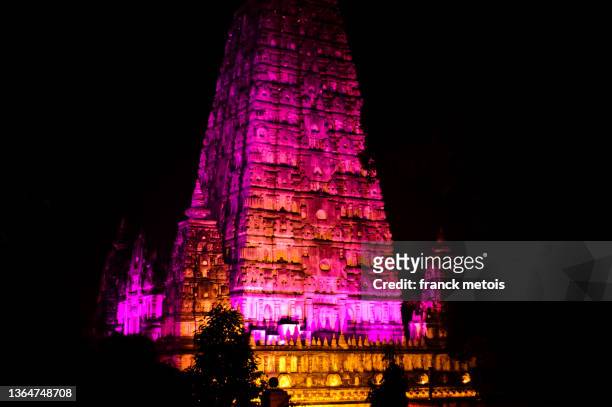 mahabodhi temple lit up at night ( india) - mahabodhi temple stock pictures, royalty-free photos & images