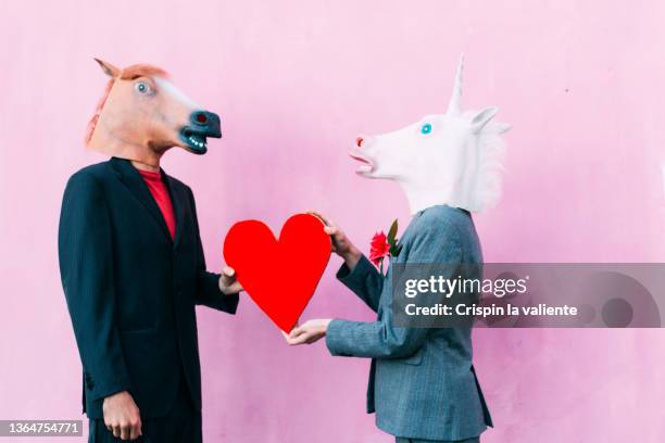 a couple with horse masks and a heart, valentine's day - animals and people imagens e fotografias de stock
