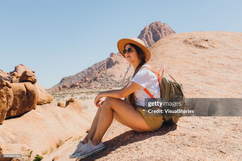 Female traveler contemplating the scenic view of Spitzkoppe from above