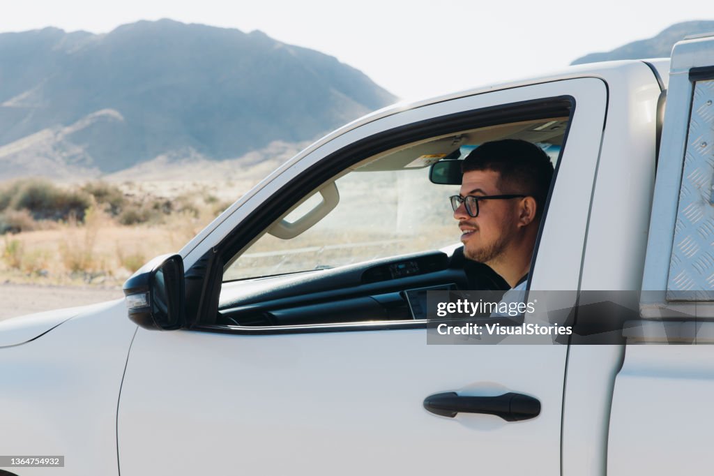 Male traveler enjoying the road trip along the desert in Namibia