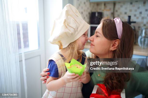 mother and daughter rub noses in the kitchen - funny hobbies stock pictures, royalty-free photos & images