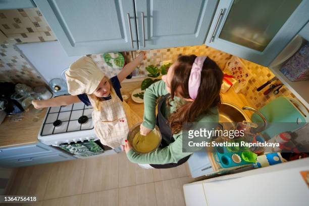 mom and daughter cooking in the kitchen - baking competition stock pictures, royalty-free photos & images
