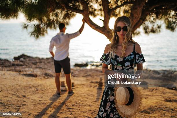 couple on the beach - petty island stock pictures, royalty-free photos & images
