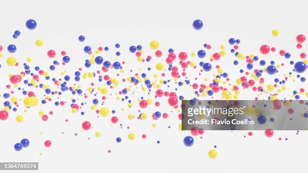 spheres with primary colors floating in the air randomly background - particle sphere stock pictures, royalty-free photos & images
