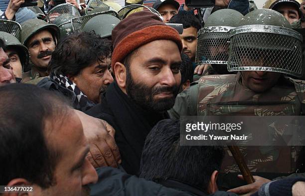 Indian policemen detain the Chairman of pro-independence Jammu and Kashmir Liberation Front Yasin Malik during a protest against the killing of a...