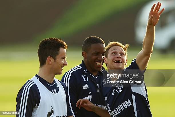 Alexander Baumjohann, Jefferson Farfan and Benedikt Hoewedes laugh during a training session of Schalke 04 at the ASPIRE Academy for Sports...