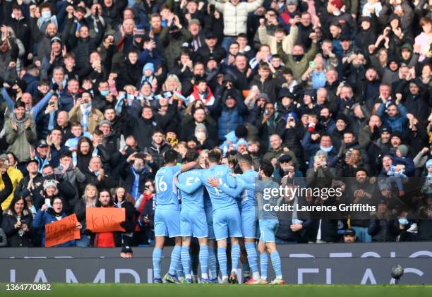 Kevin De Bruyne celebrates with teammates Rodrigo, John Stones, Aymeric Laporte, Jack Grealish and Bernardo Silva of Manchester City after scoring...