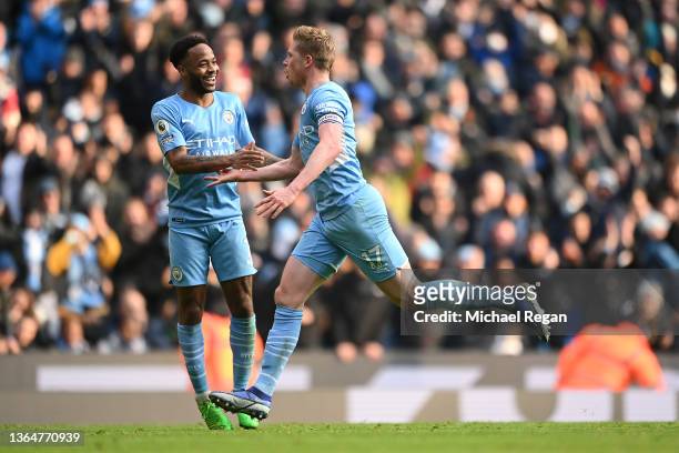 Kevin De Bruyne celebrates with teammate Raheem Sterling of Manchester City after scoring their team's first goal during the Premier League match...