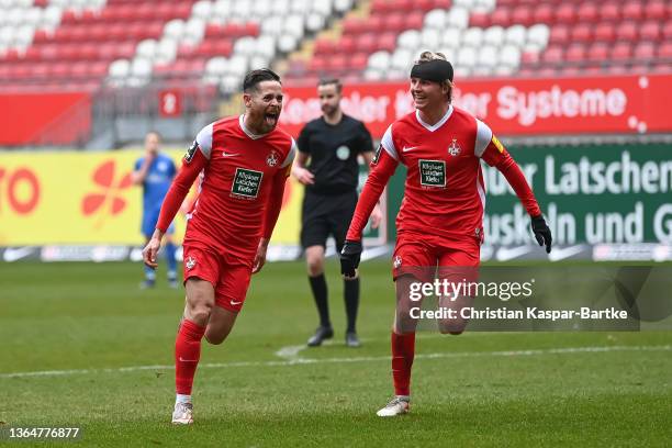 Mike Wunderlich of 1.FC Kaiserslautern celebrates after scoring his team`s fourth goal with teammate Felix Goetze of 1.FC Kaiserslautern during the...