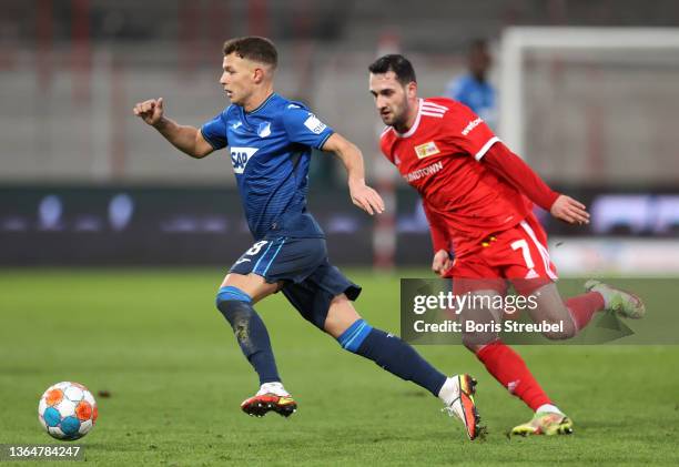 Dennis Geiger of TSG 1899 Hoffenheim is closed down by Levin Oeztunali of 1.FC Union Berlin during the Bundesliga match between 1. FC Union Berlin...