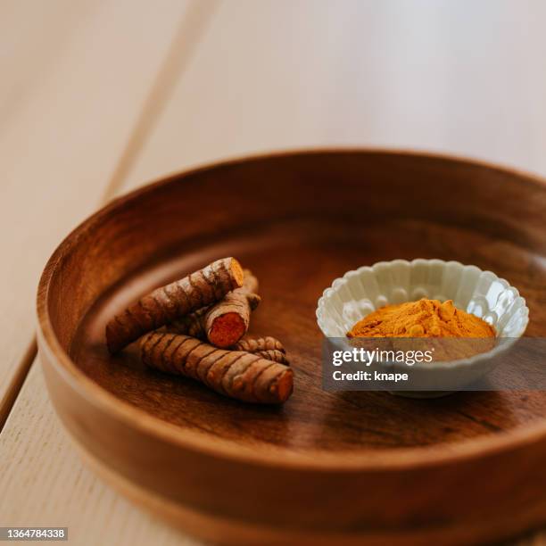 healthy food still life turmeric root and powder curcuma longa - orange powder stock pictures, royalty-free photos & images