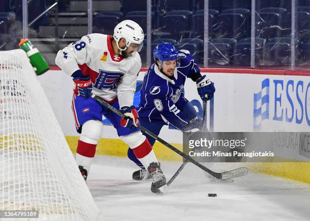 Peter Abbandonato of the Laval Rocket and Jesse Lees of the Syracuse Crunch battle for the puck during the second period at Place Bell on January 12,...