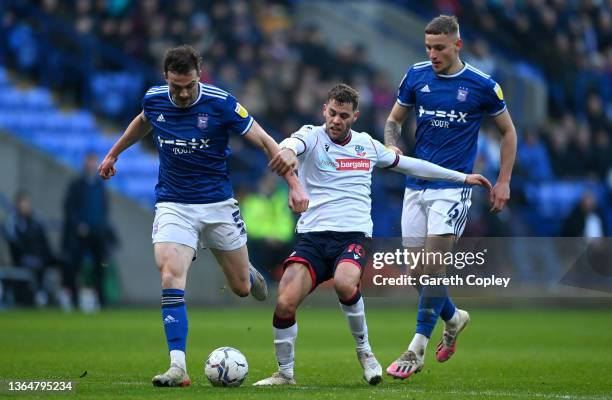 Dion Charles of Bolton is tackled by George Edmundson and Luke Woolfenden of Ipswich during the Sky Bet League One match between Bolton Wanderers and...