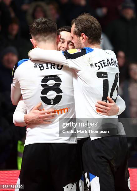 Tom Lawrence celebrates with teammates Max Bird and Richard Stearman of Derby County after scoring their team's first goal during the Sky Bet...