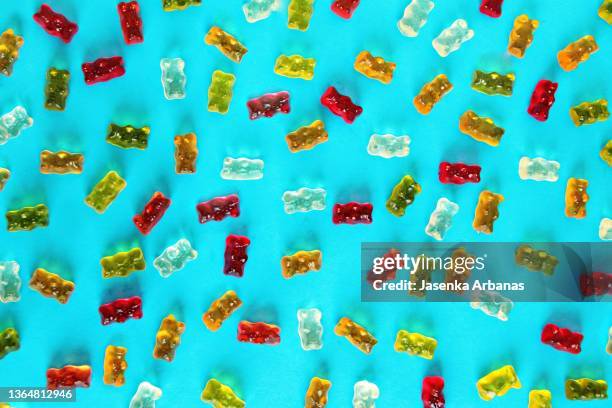 gummy  fruit  bears on the turquoise background - gummi bears ストックフォトと��画像