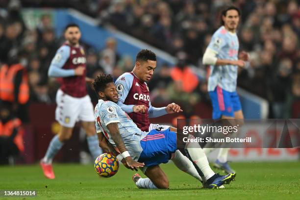 Jacob Ramsey of Aston Villa tackles Fred of Manchester United during the Premier League match between Aston Villa and Manchester United at Villa Park...