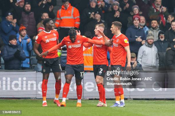 Elijah Adebayo of Luton Town is congratulated by team-mates after his shot is deflected in by Lloyd Kelly of Bournemouth to give Luton a one-nil lead...