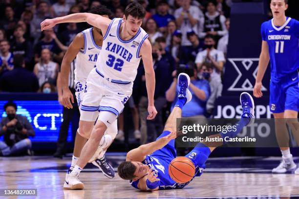 Ryan Hawkins of the Creighton Bluejays and Zach Freemantle of the Xavier Musketeers fight for the ball during the first half at Cintas Center on...