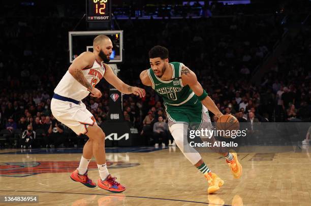 Jayson Tatum of the Boston Celtics drives against Evan Fournier of the New York Knicks during their game at Madison Square Garden on January 06, 2022...