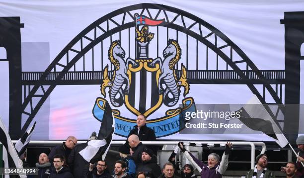 Flag showing the Tyne Bridge is pictured alongside fans in the Gallowgate End during the Premier League match between Newcastle United and Watford at...