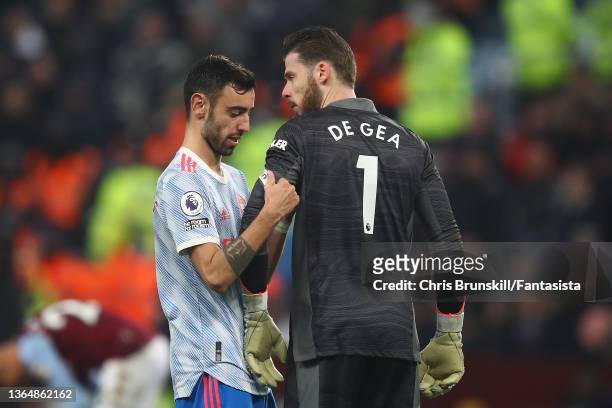Bruno Fernandes of Manchester United gives the captain's armband to team-mate David De Gea during the Premier League match between Aston Villa and...