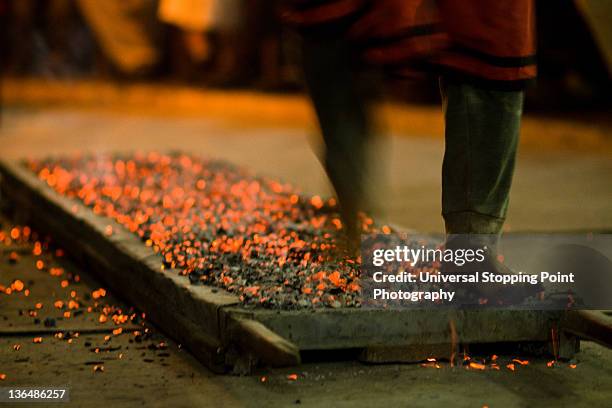 man walking barefoot across bed of hot coals - coal men stock pictures, royalty-free photos & images