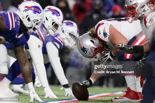 David Andrews of the New England Patriots prepares to snap the ball against the Buffalo Bills during the first quarter in the AFC Wild Card playoff...