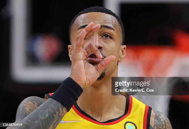 John Collins of the Atlanta Hawks reacts after a three-point basket against the New York Knicks during the first half at State Farm Arena on January...